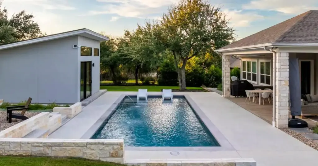 Designing A Luxurious Pool In The Diverse Austin Landscape 2 a pool with sun shelf, lounge chairs and patio in the flatlands of the east in Austin Texas